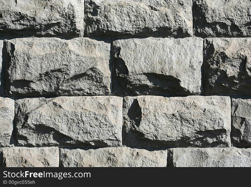 Rough stone wall in a morning sunlight as a background