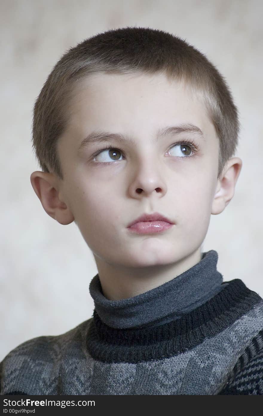 Serious boy portrait on light background