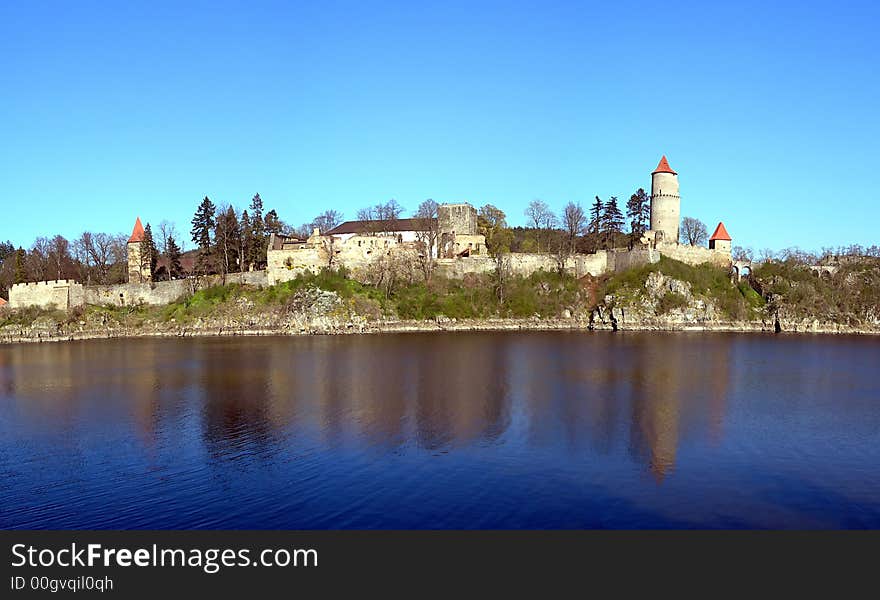 Old medieval czech castle with turrets, walls and a lake around it. Old medieval czech castle with turrets, walls and a lake around it.