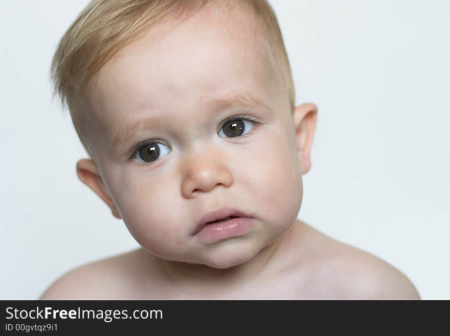 Image of beautiful toddler with a serious look on his face. Image of beautiful toddler with a serious look on his face