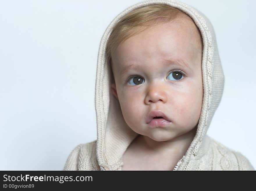 Image of beautiful toddler wearing a hooded sweater. Image of beautiful toddler wearing a hooded sweater