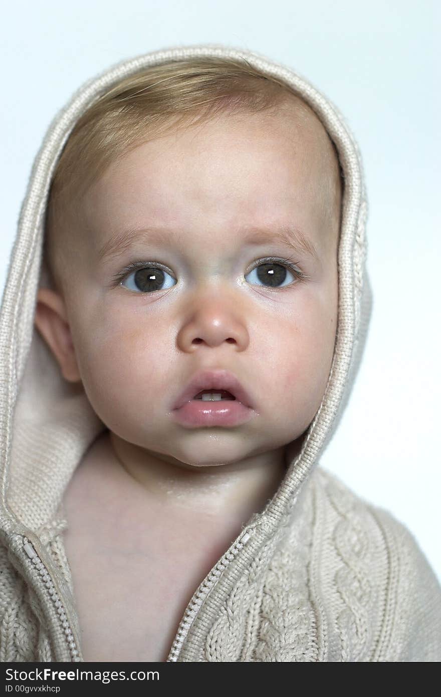 Image of beautiful toddler wearing a hooded sweater. Image of beautiful toddler wearing a hooded sweater