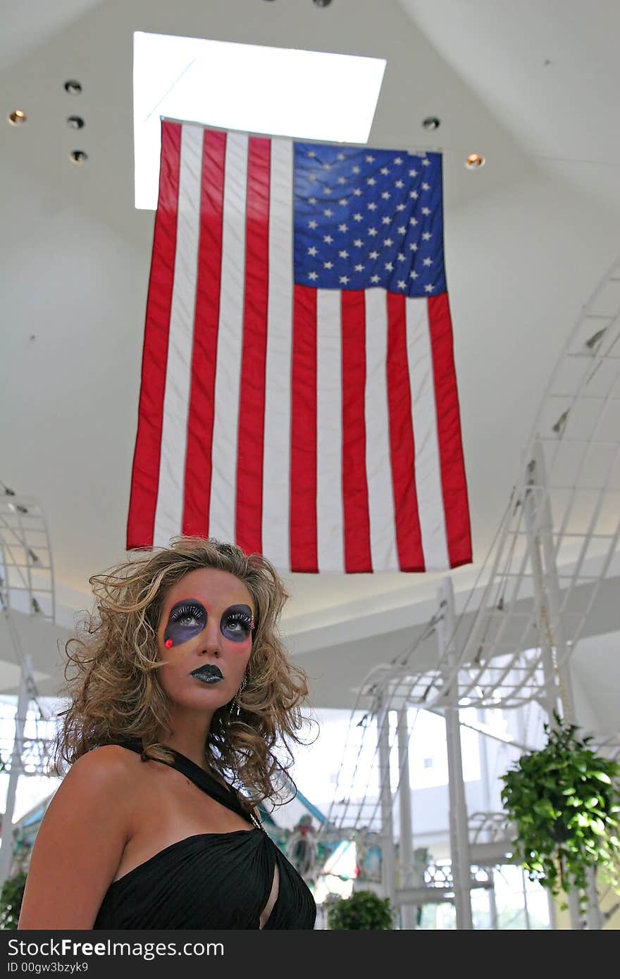 Extreme makeup model in mall under U.S. Flag. Extreme makeup model in mall under U.S. Flag