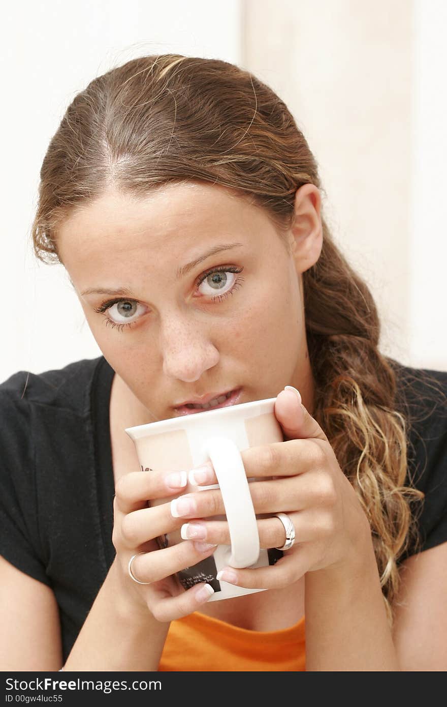 Fifteen year old girl is drinking coffee. Fifteen year old girl is drinking coffee