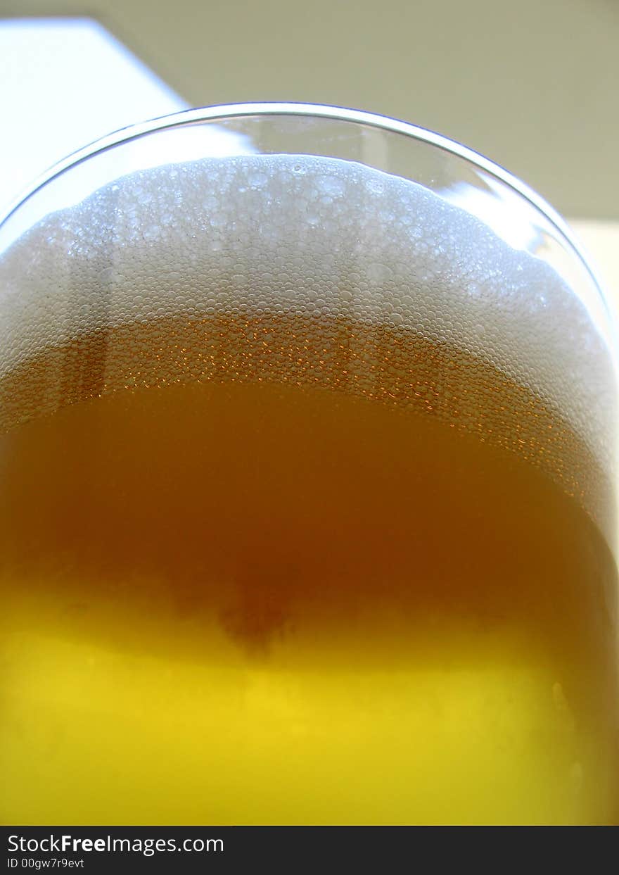 Drinking time... cold beer in summer time, beer in glass, focus on beer froth,. Drinking time... cold beer in summer time, beer in glass, focus on beer froth,