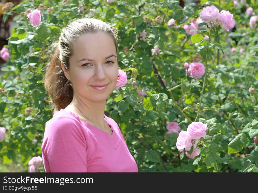 Beautiful young smiling girl portrait with foliage