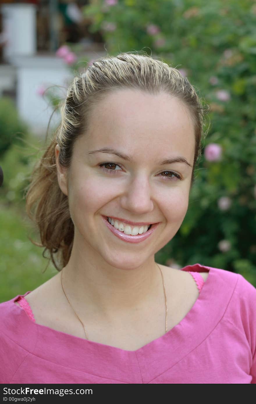 Beautiful young smiling girl portrait with foliage