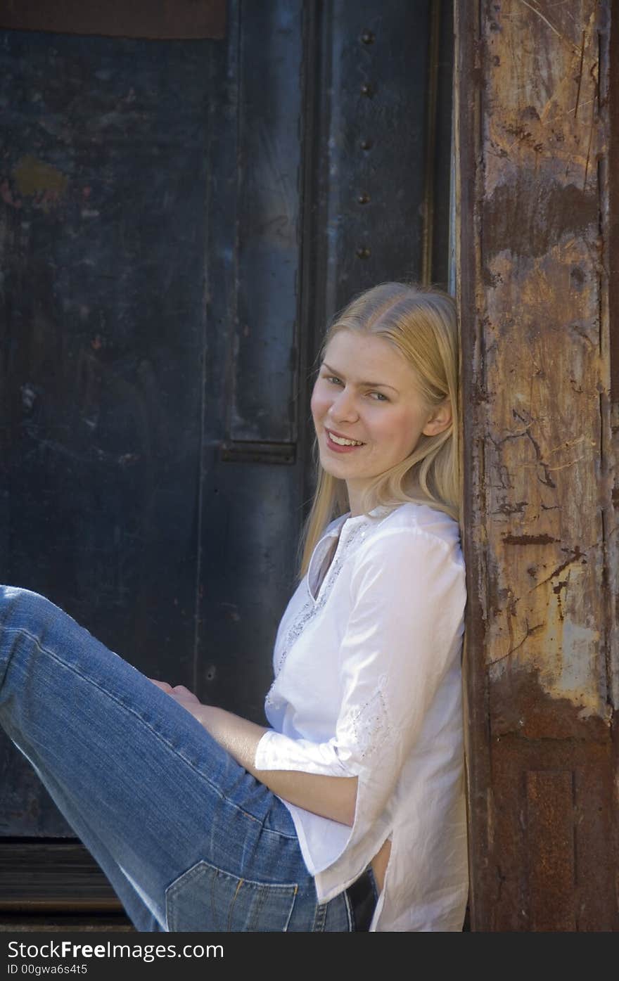 Young blond woman gazing at the camera with a pretty smile. Young blond woman gazing at the camera with a pretty smile.