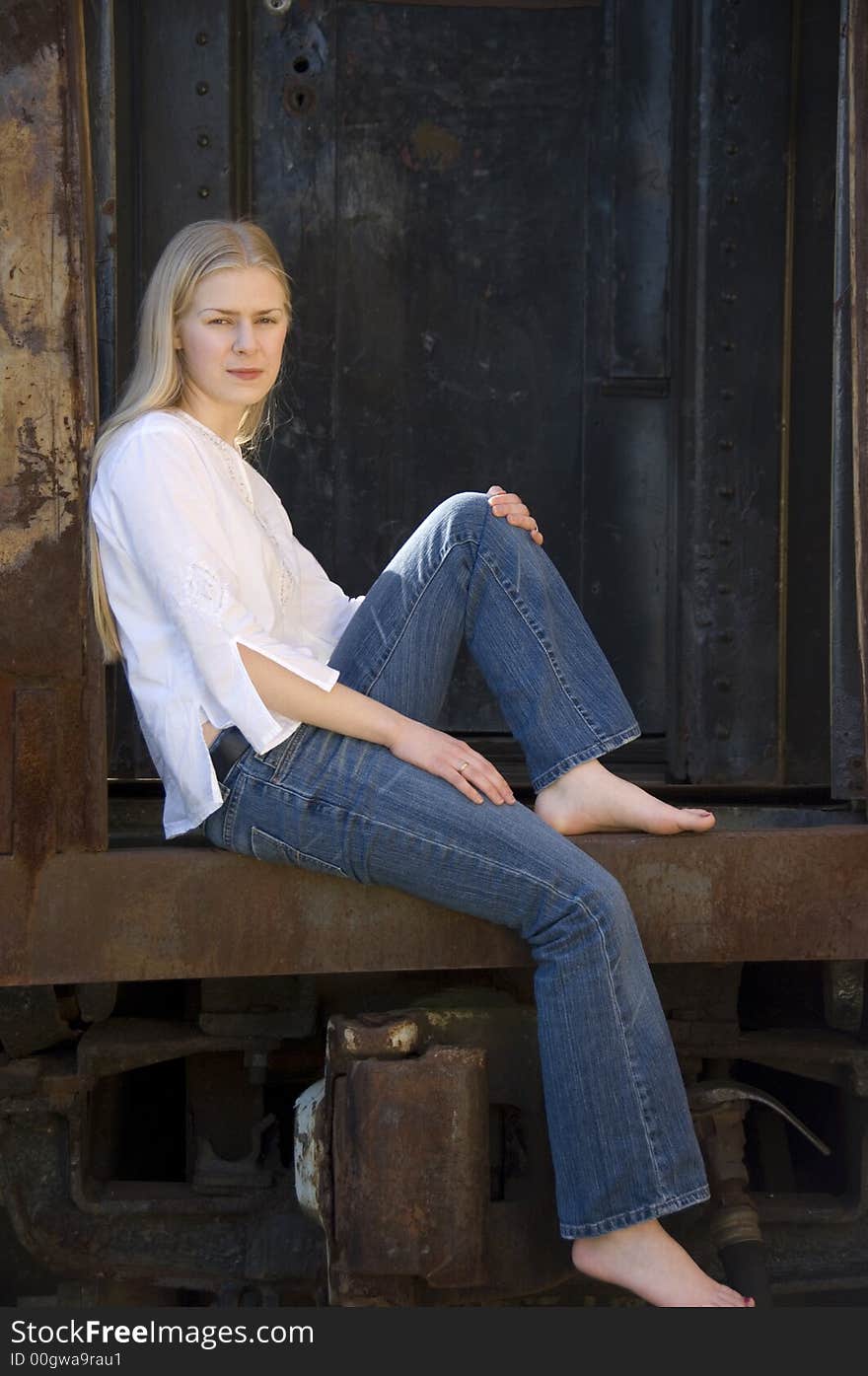 Young blond attractive woman with a serious expression, as though thinking about something sad or depressing. Young blond attractive woman with a serious expression, as though thinking about something sad or depressing.