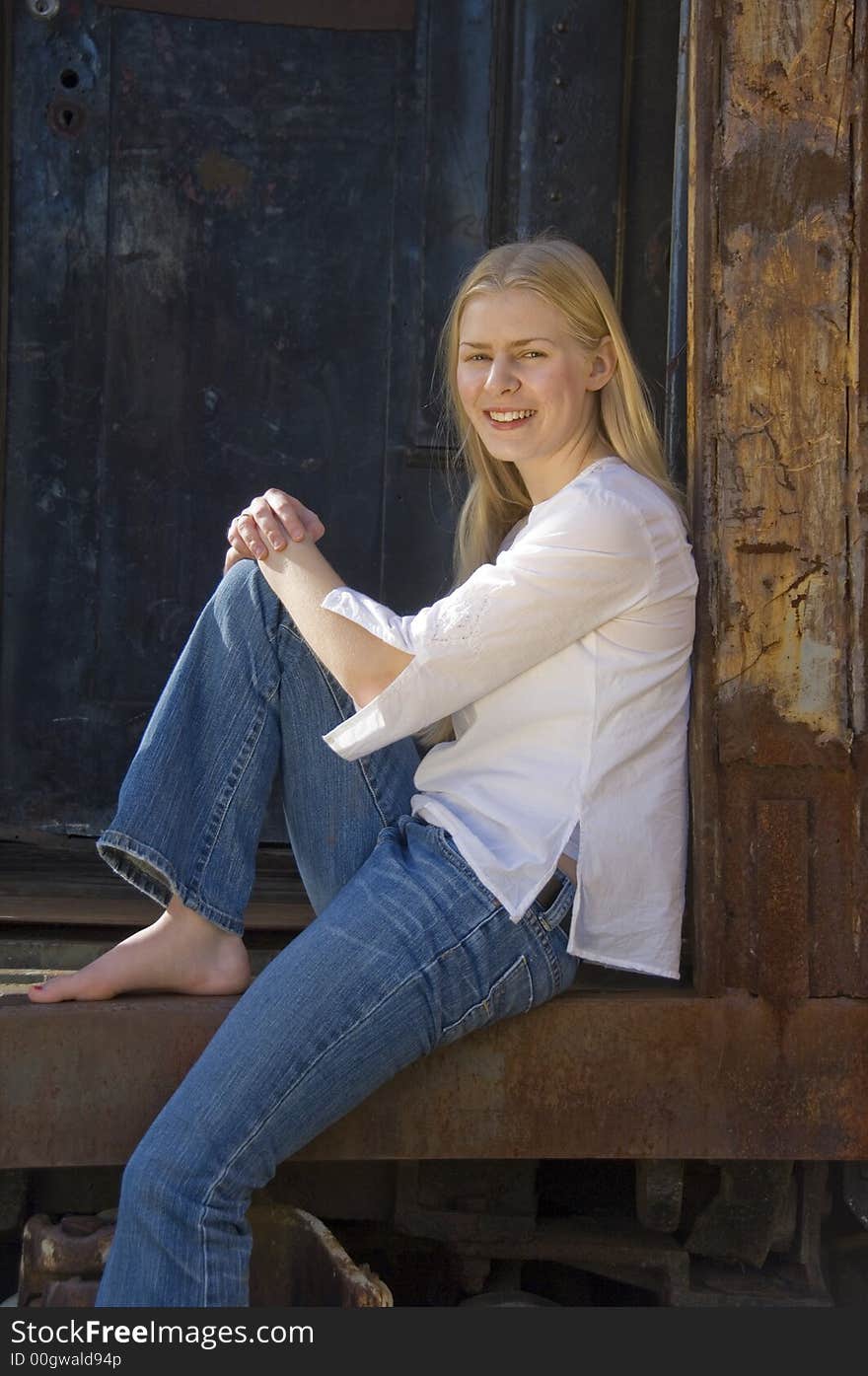 Young blond woman gazing at the camera with a pretty smile. Young blond woman gazing at the camera with a pretty smile.