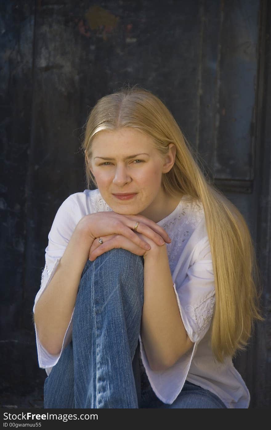 Young blond woman gazing at the camera with a pretty smile. Young blond woman gazing at the camera with a pretty smile.