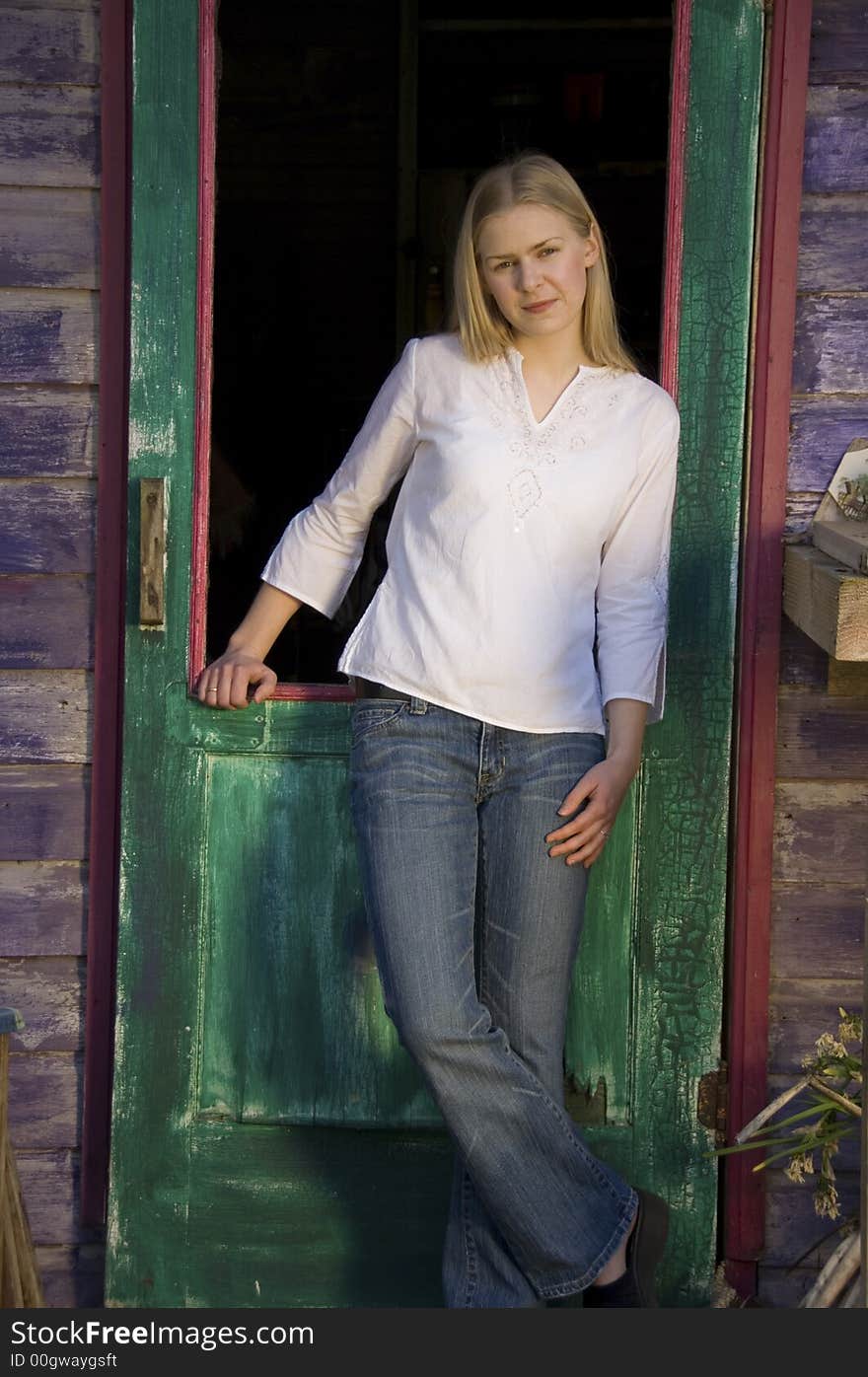 Blond Girl In Rustic Doorway