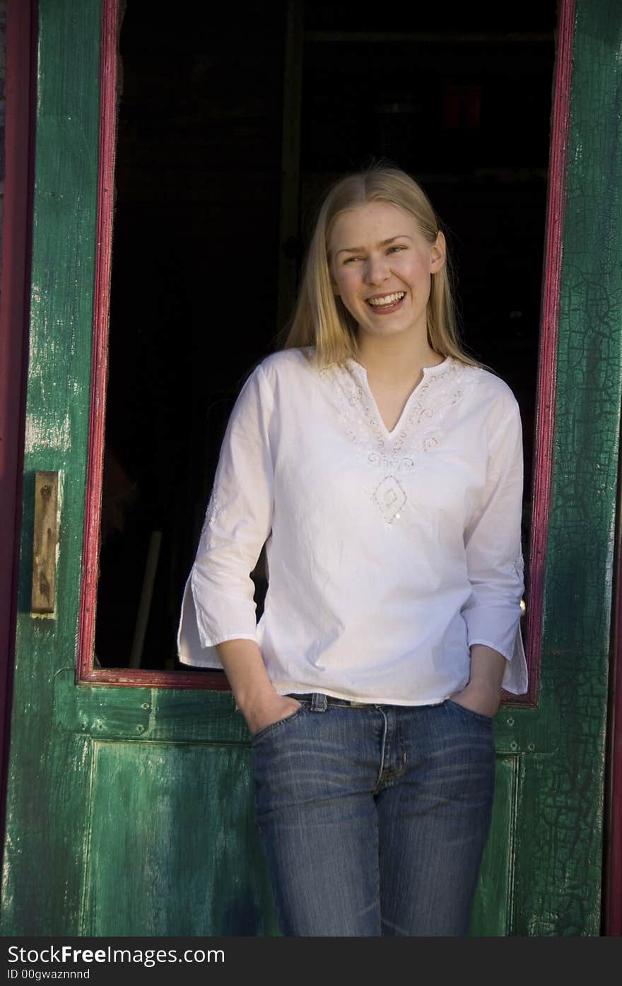 Young blond woman gazing at the camera with a pretty smile. Young blond woman gazing at the camera with a pretty smile.