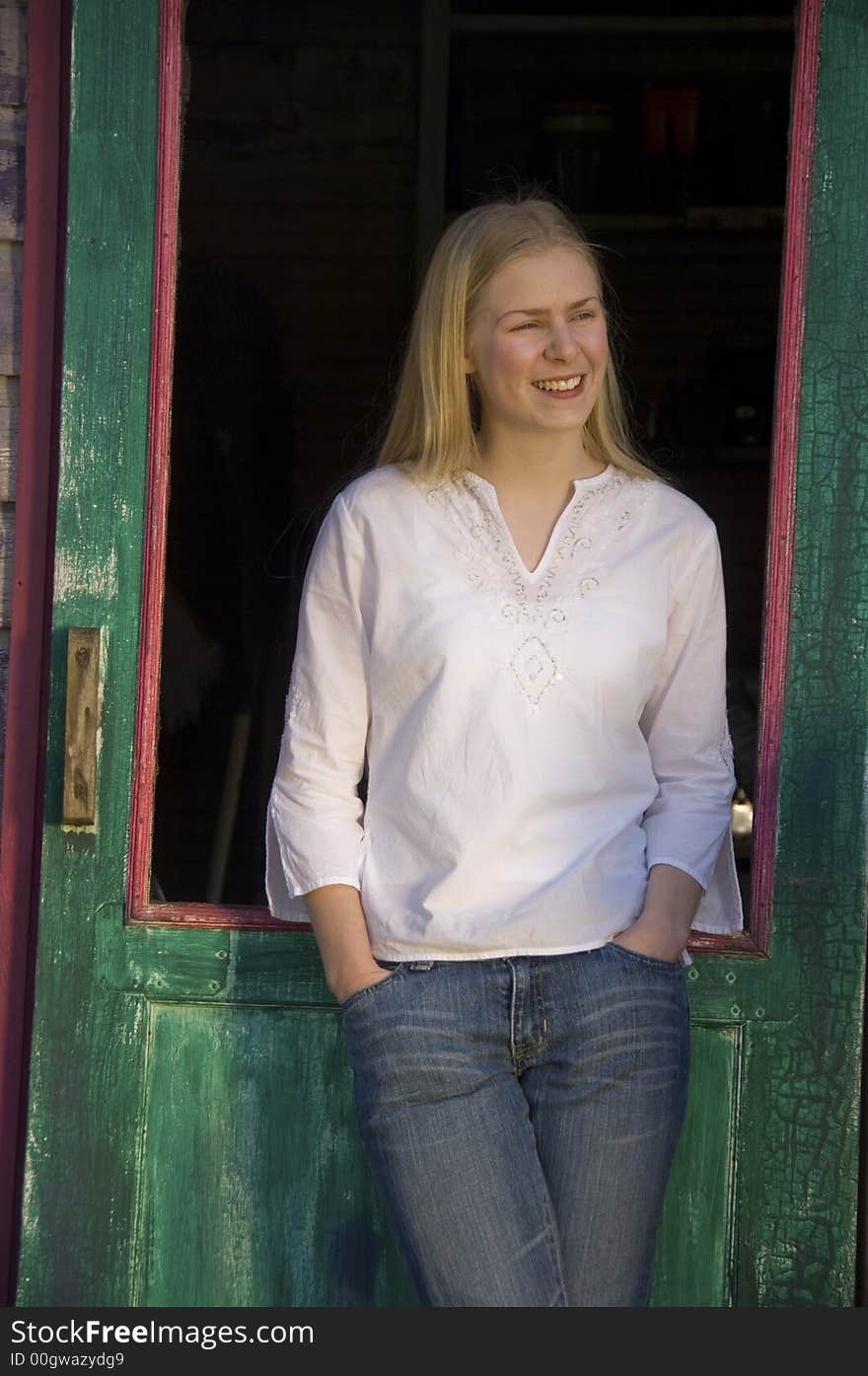 Young blond woman gazing at the camera with a pretty smile. Young blond woman gazing at the camera with a pretty smile.