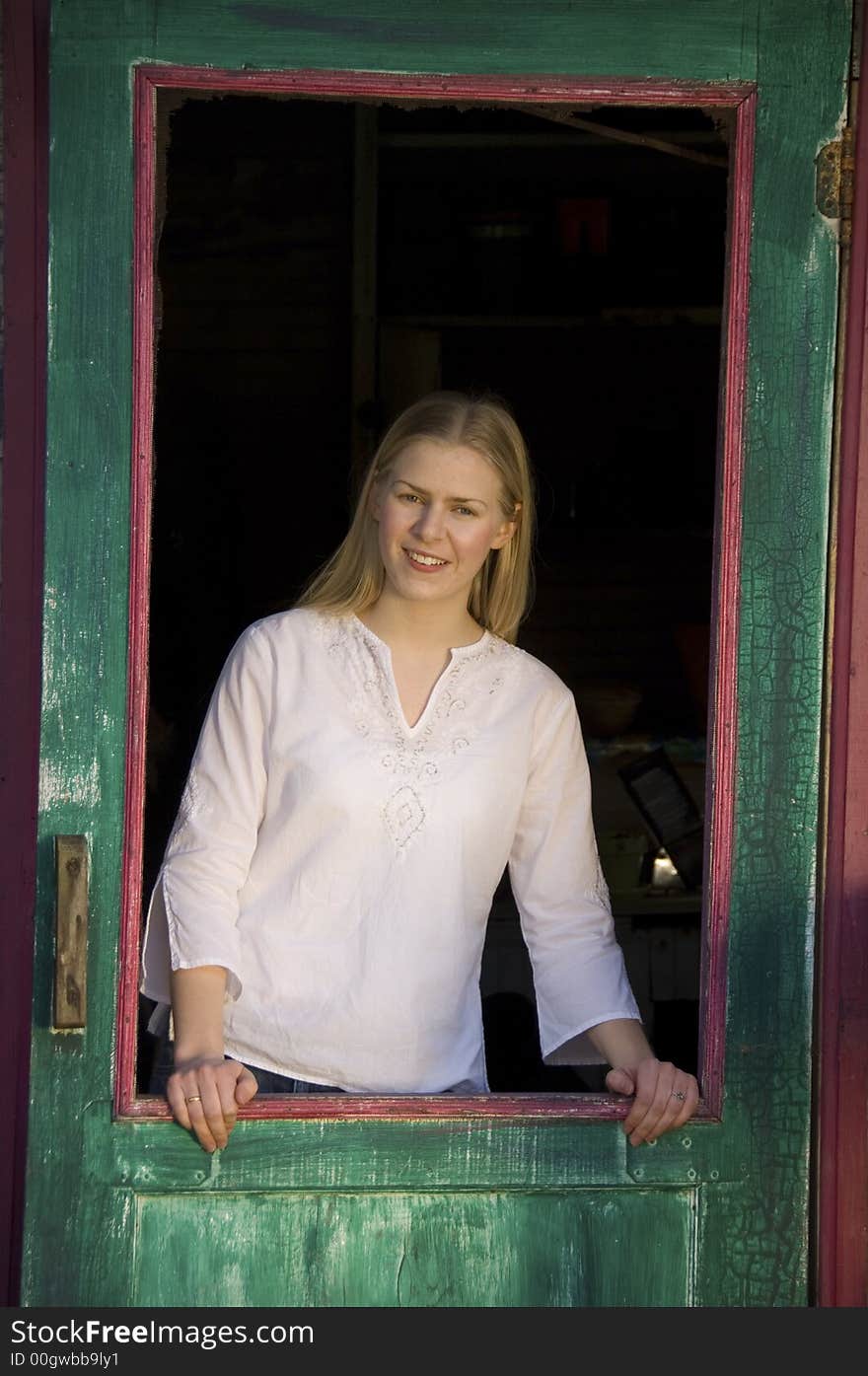 Young blond woman gazing at the camera with a pretty smile. Young blond woman gazing at the camera with a pretty smile.