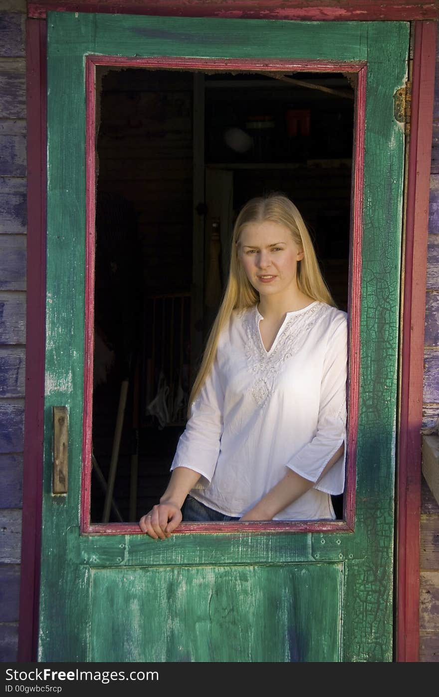 Young blond woman gazing at the camera with a pretty smile. Young blond woman gazing at the camera with a pretty smile.