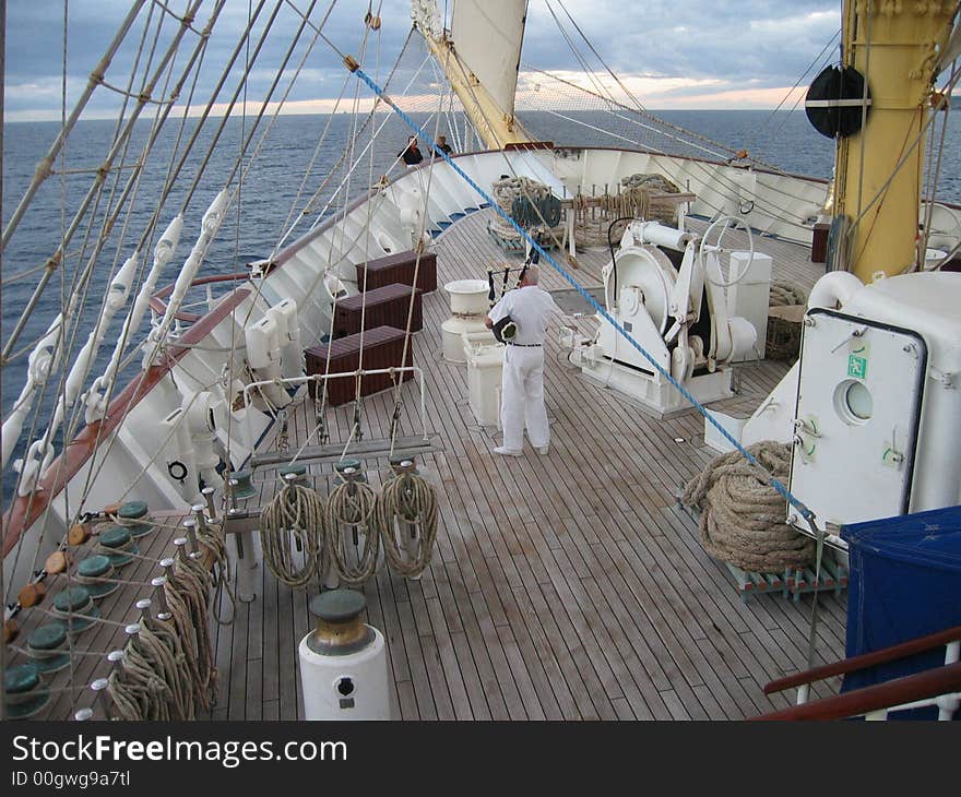 Captain of the Royal Clipper playing on bagpipes standing on deck during cruise. Captain of the Royal Clipper playing on bagpipes standing on deck during cruise