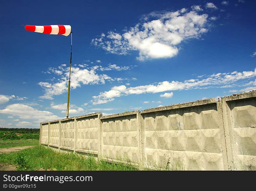 Red and white windsock with wall