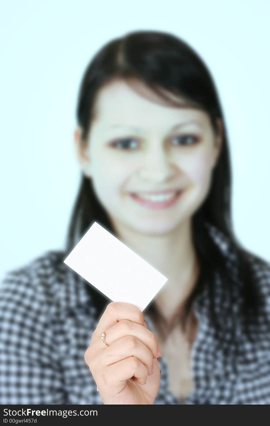 The young business woman holds a card. The young business woman holds a card