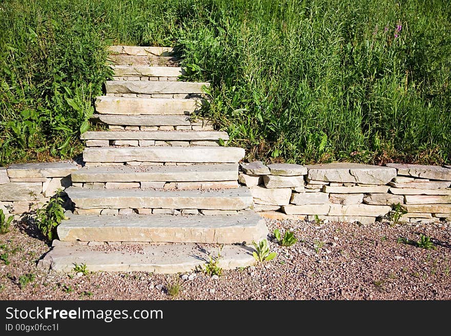 Stairs ending in to middle of grass field