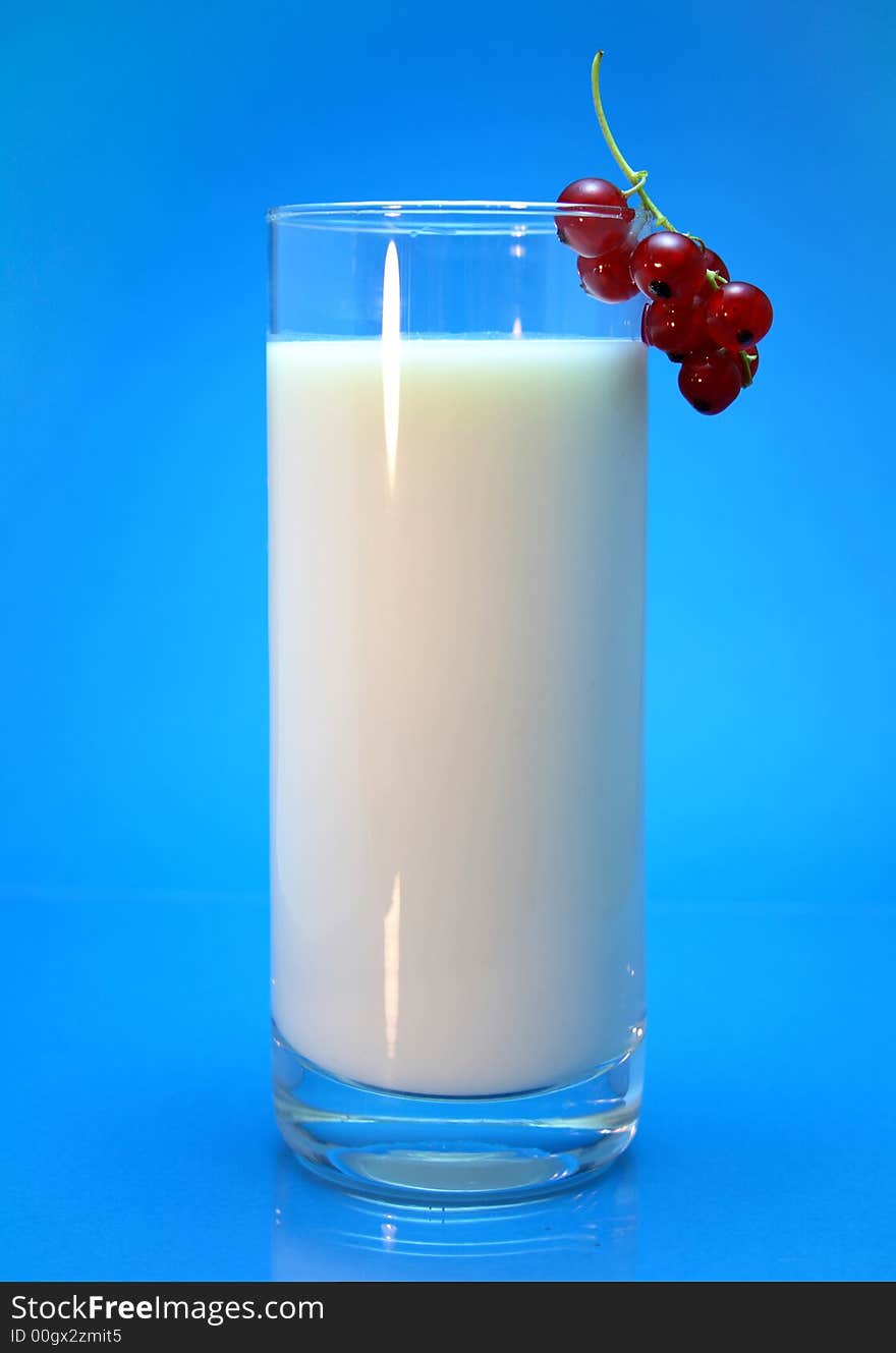 Milk in glass over blue background. Milk in glass over blue background