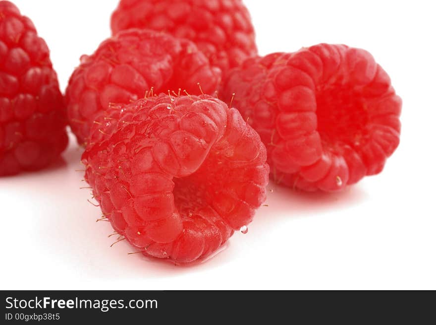 Ripe red raspberries isolated on a white background.