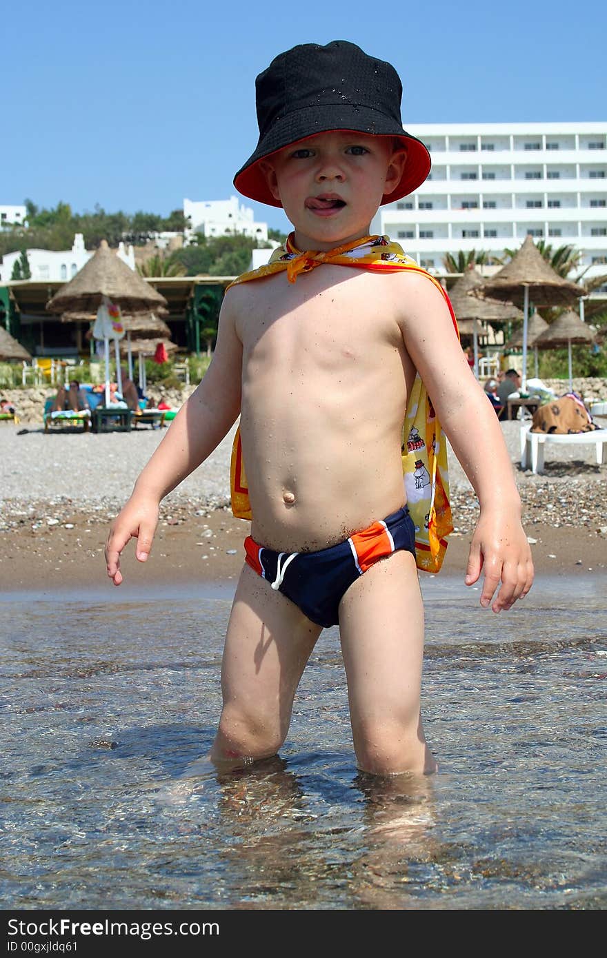 Small boy knee-deep in the sea, Rhodes, Greece. Small boy knee-deep in the sea, Rhodes, Greece