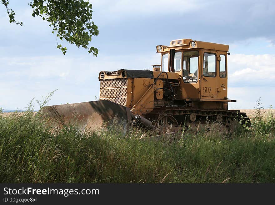 Front Loader sits in grass