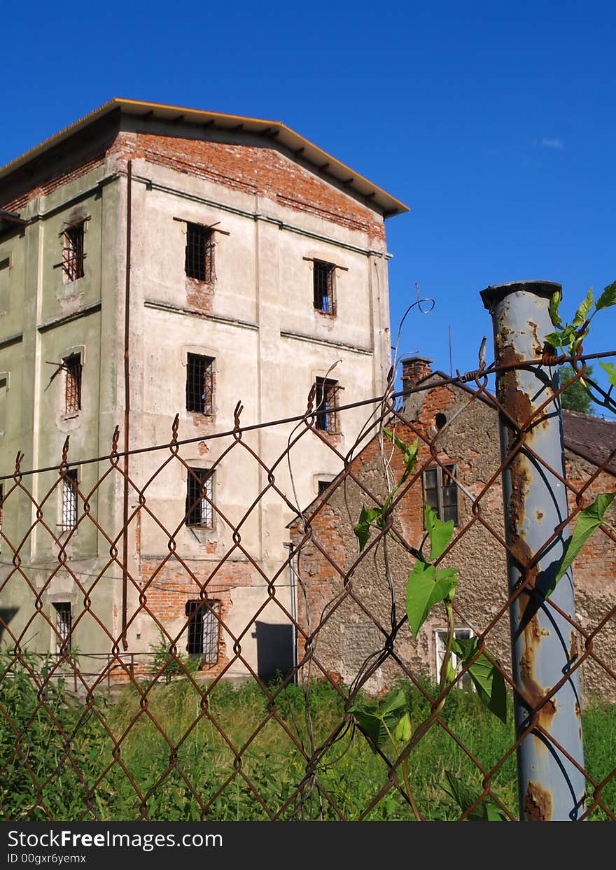 Abandoned mansion behind a fence