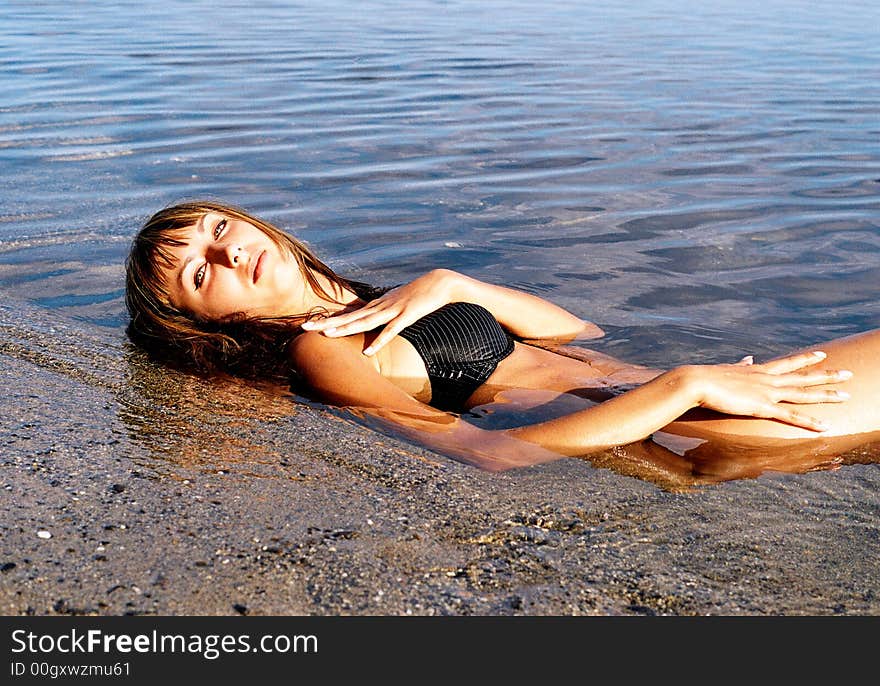 Portrait of beautiful girl relaxing at the sea. Portrait of beautiful girl relaxing at the sea.