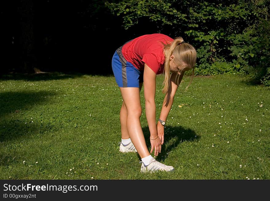 Woman making of the stretching in full nature. Woman making of the stretching in full nature