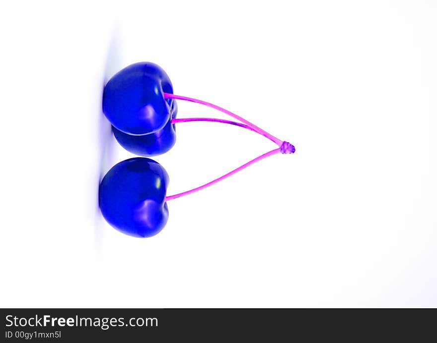 Three blue cherries on the white background. Three blue cherries on the white background