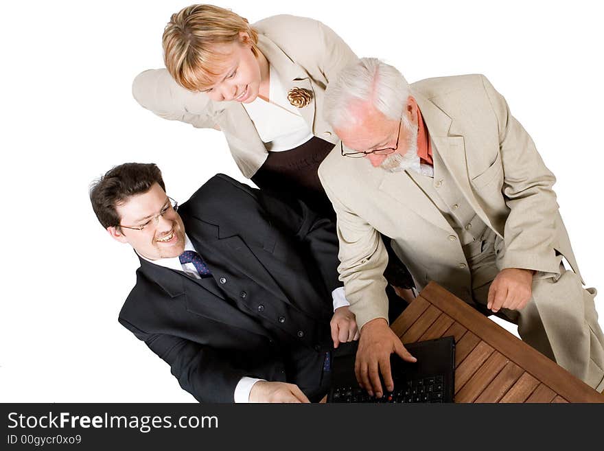 A business team looking at a laptop (2). A business team looking at a laptop (2)