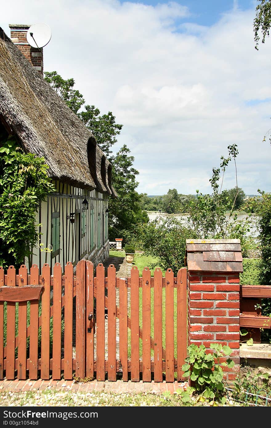 Thatched Riverside Cottage in Normandy, France with a picket Gate. Thatched Riverside Cottage in Normandy, France with a picket Gate