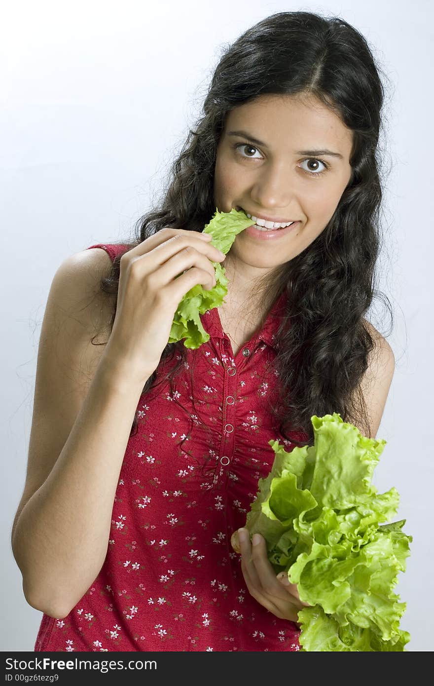 Pretty girl holding fresh lettuce and eating. Pretty girl holding fresh lettuce and eating