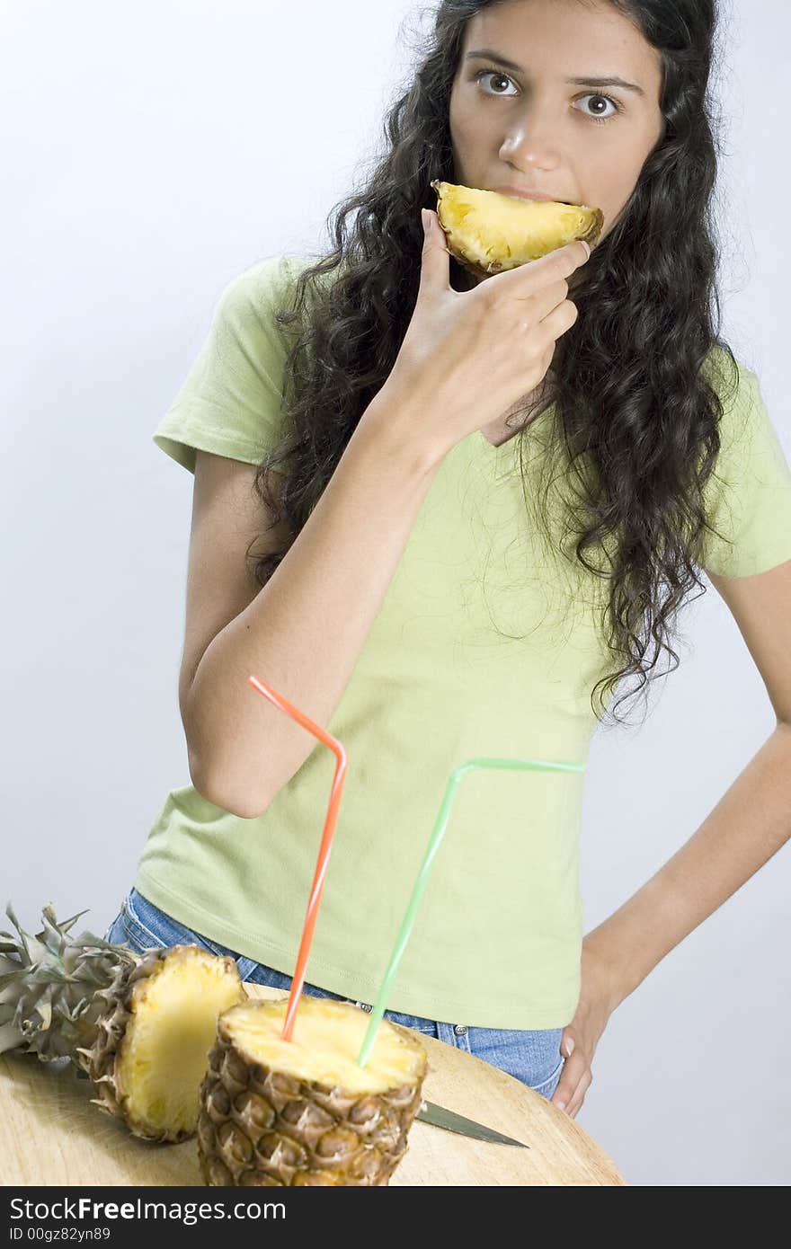 Girl eating pineapple