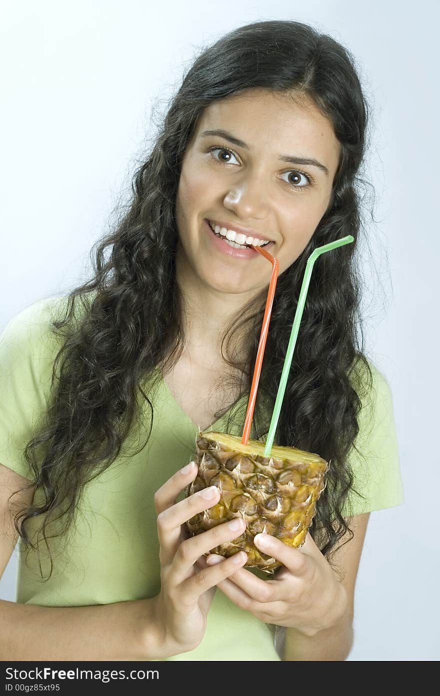 Smiling girl drinking fresh pineapple. Smiling girl drinking fresh pineapple