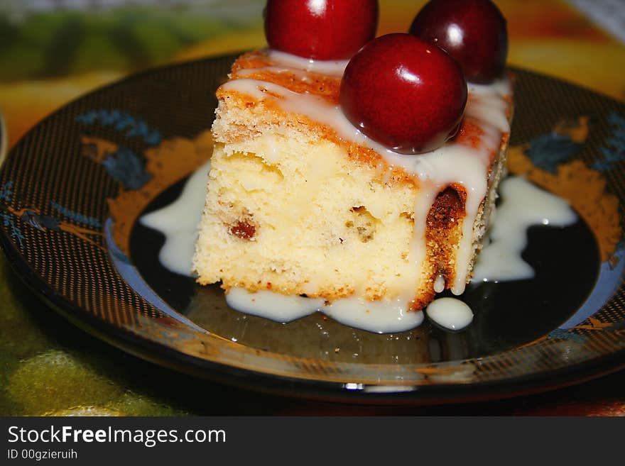 Sweet fruitcake with a cherry and the condensed milk. Sweet fruitcake with a cherry and the condensed milk