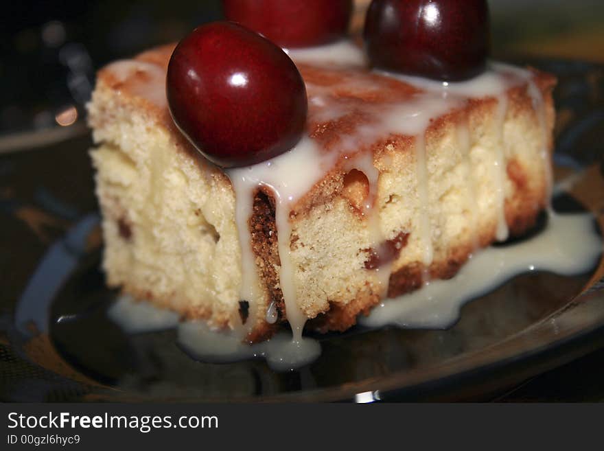 Sweet fruitcake with a cherry and the condensed milk. Sweet fruitcake with a cherry and the condensed milk