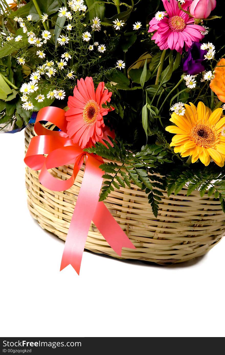 Colorful flowers in brown basket over white. Colorful flowers in brown basket over white