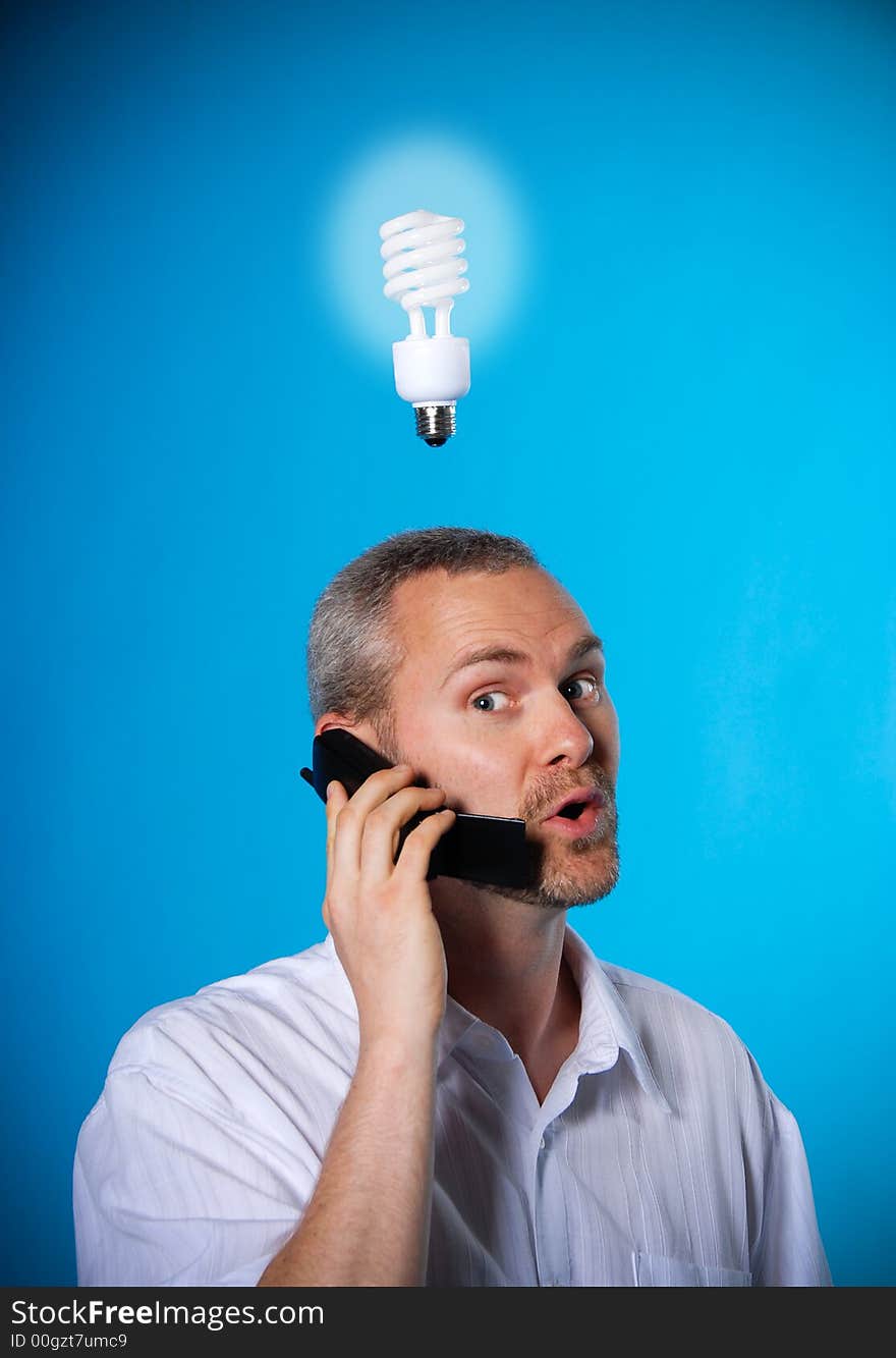 Man with a beard with a light bulb on the phone. Man with a beard with a light bulb on the phone