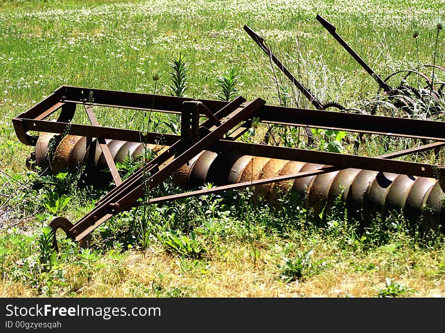 Antique soil pulverisor attached to tractor to break up soil and level it. Antique soil pulverisor attached to tractor to break up soil and level it