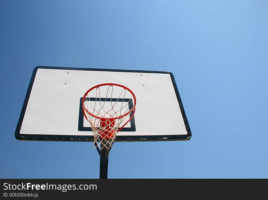 Basketball hoop, street basketball under clear blue sky. Basketball hoop, street basketball under clear blue sky