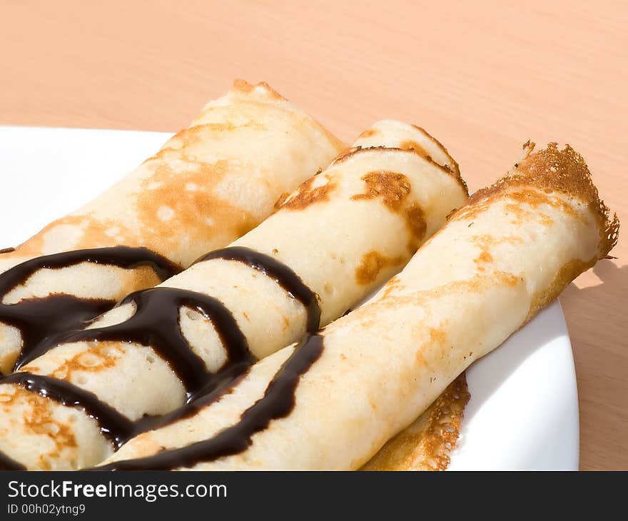 Three twisted pancakes with chocolate. Three twisted pancakes with chocolate