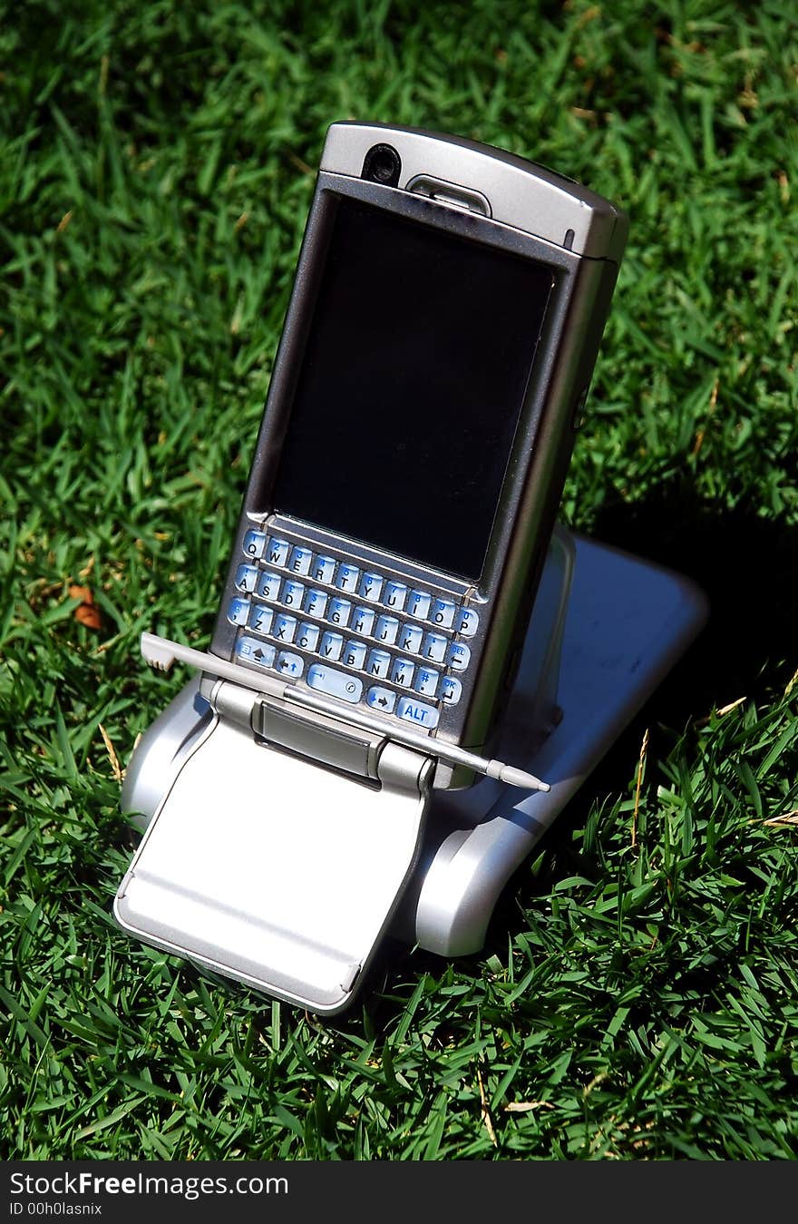 Pda phone image on the green grass background