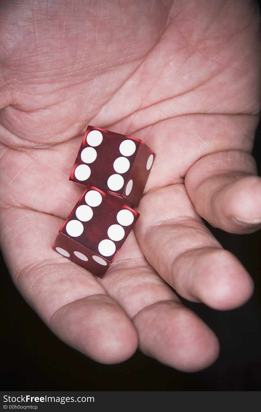 A Man's hand holding lucky poker dice. A Man's hand holding lucky poker dice