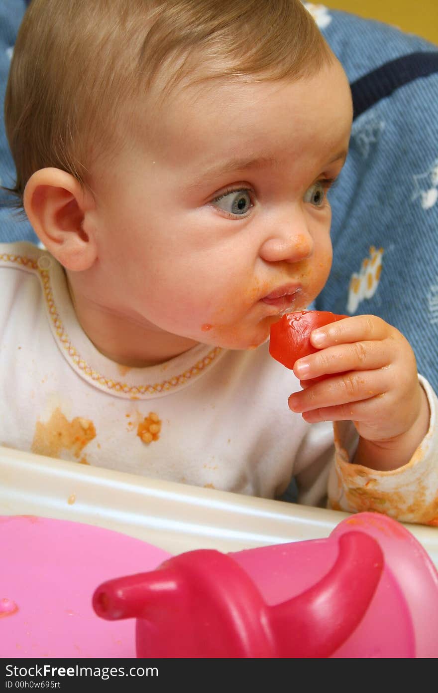 A baby is eating lunch. A baby is eating lunch.