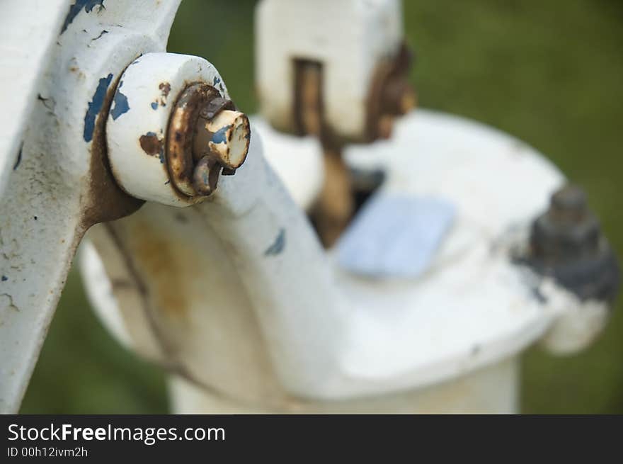 Detail of old white water pump with the blue soap.