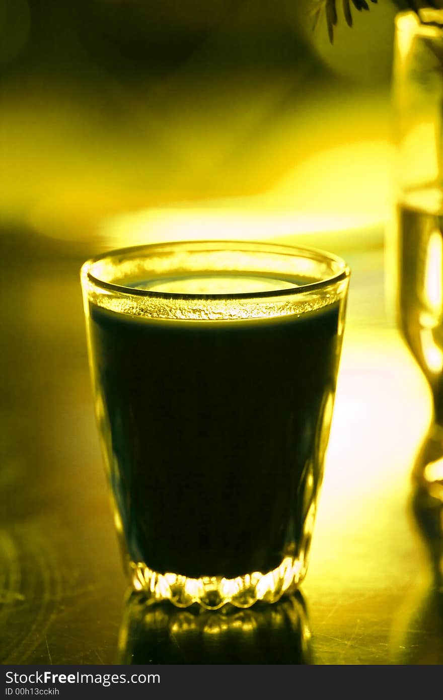 Glass with beverage on yellow color