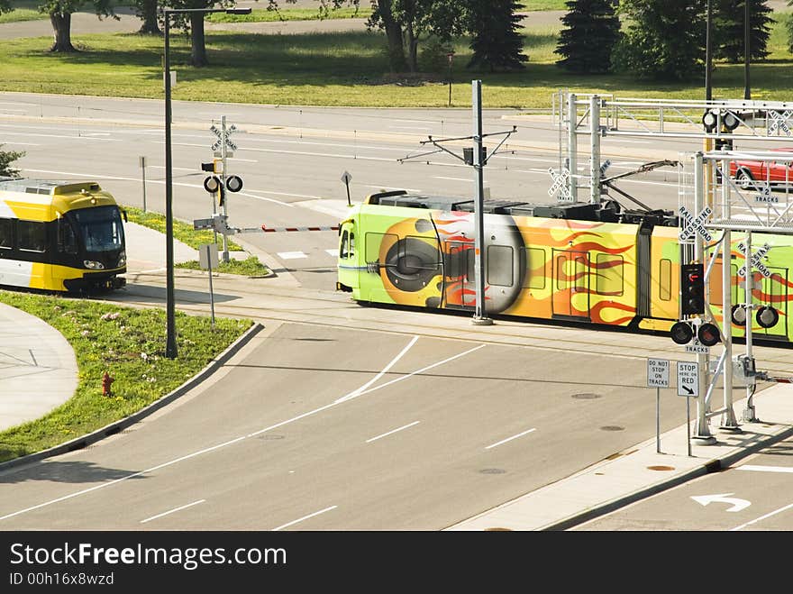 Light rail mass transit trains cross at an intersection in Bloomington, MN. Light rail mass transit trains cross at an intersection in Bloomington, MN